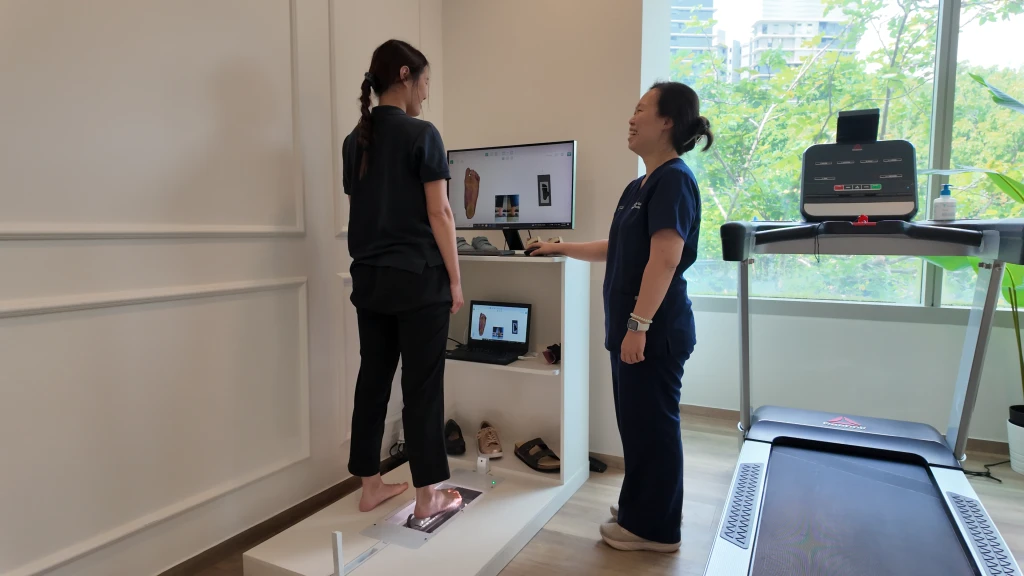 Podiatrist at Straits Podiatry assessing and treating Flat Feet in Singapore
