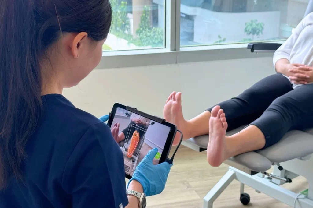 podiatrist doing 3d foot scan for custom insoles