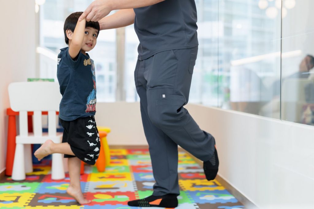 podiatrist examining child with toe walking symptoms
