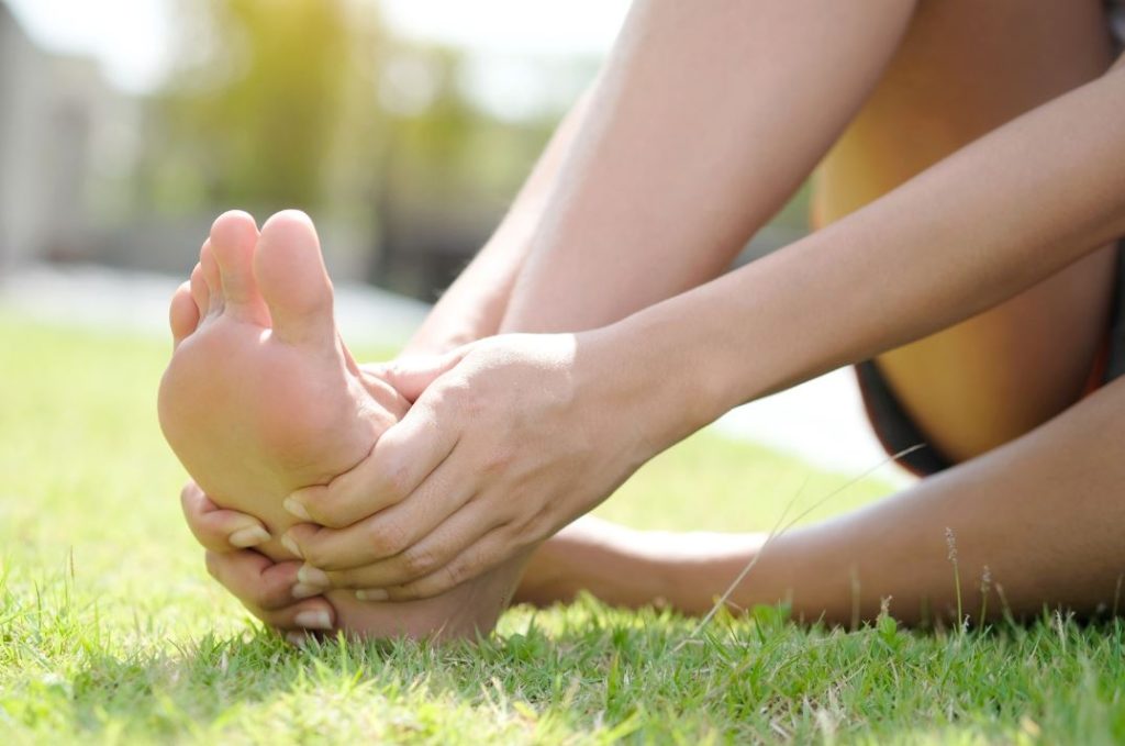 Woman suffering from right foot pain in Singapore. Straits Podiatry
