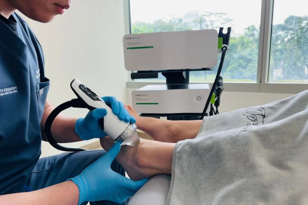 Podiatrist at Straits Podiatry assessing and treating Ankle Pain in Singapore