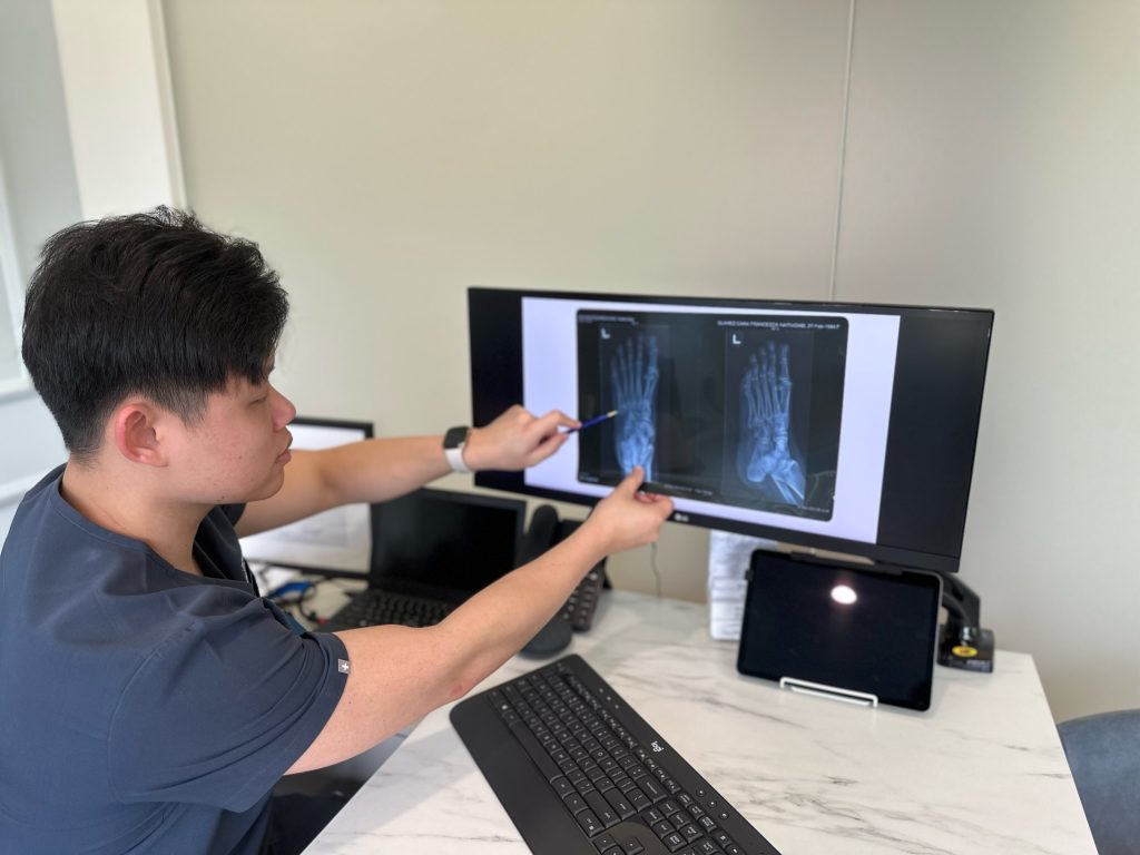 podiatrist reviewing x-ray to diagnose foot pain