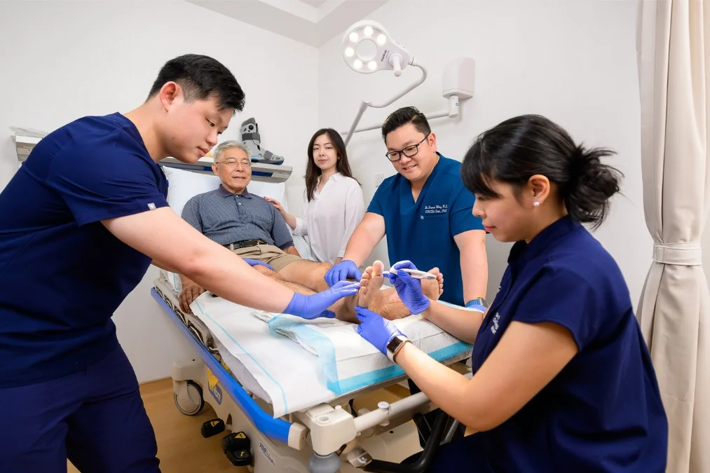 Orthopaedic doctor and podiatrists assessing diabetic foot