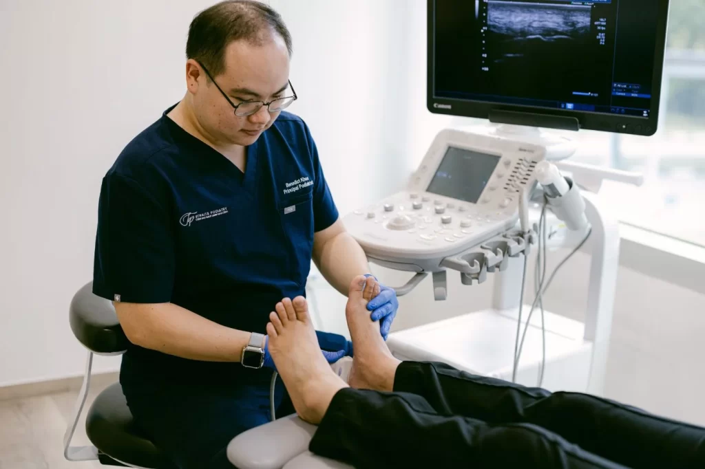 podiatrist assessing patient with arch pain