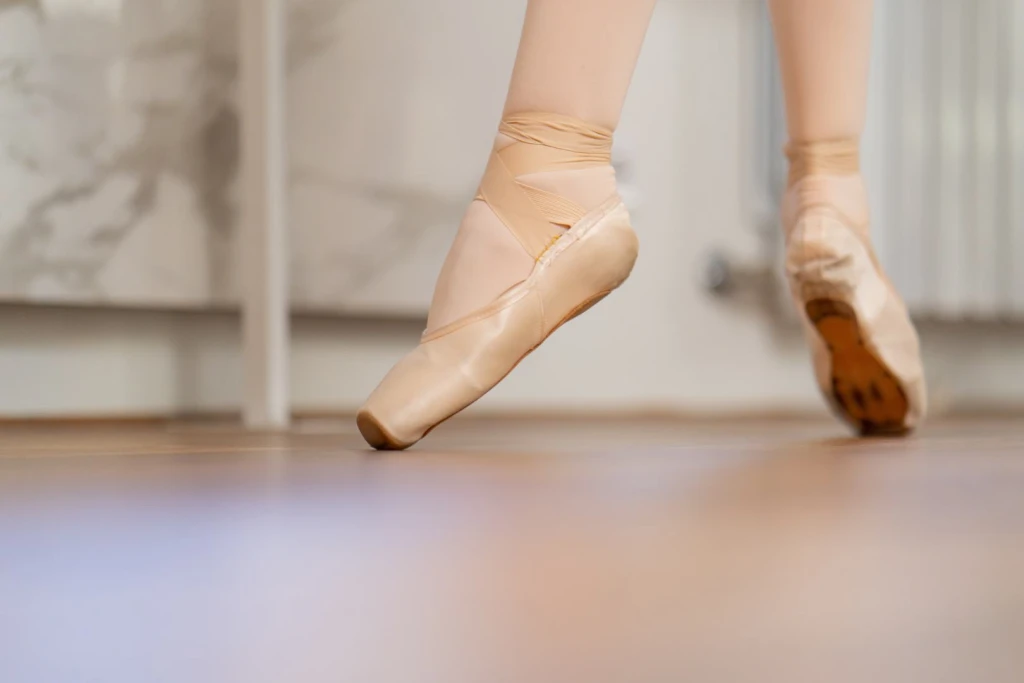 Foot in full ballet pointe position, showing the forced plantarflexion mechanism that commonly triggers posterior ankle impingement.