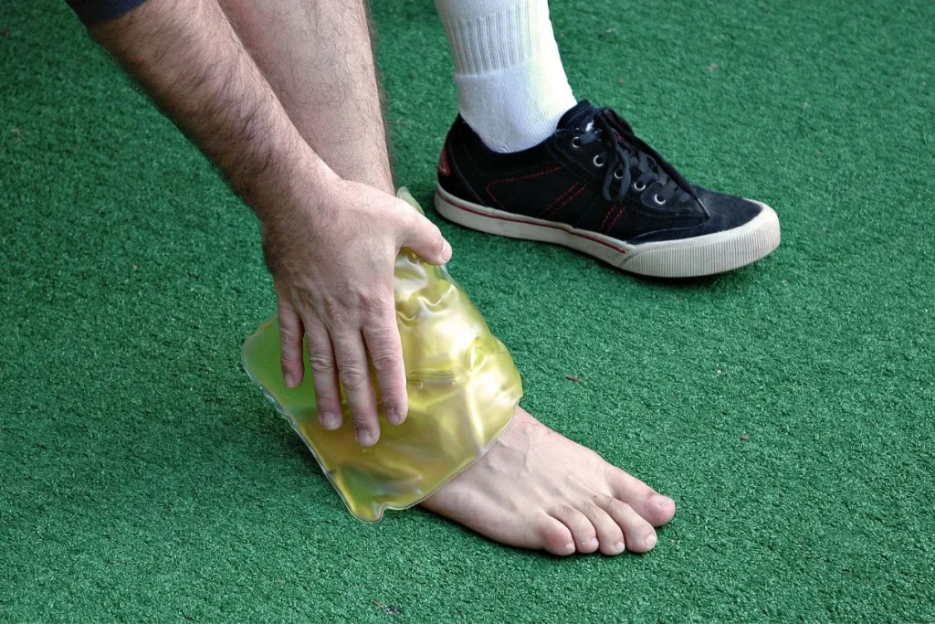 person icing his ankle after a sprain