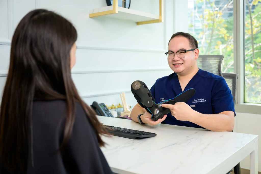 Podiatrist at Straits Podiatry assessing and treating High Ankle Sprain in Singapore
