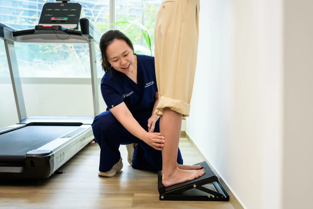 Podiatrist at Straits Podiatry assessing and treating Leg Pain in Singapore