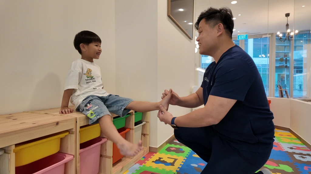 Podiatrist assessing the foot and lower limb to identify factors contributing to Metatarsus Adductus