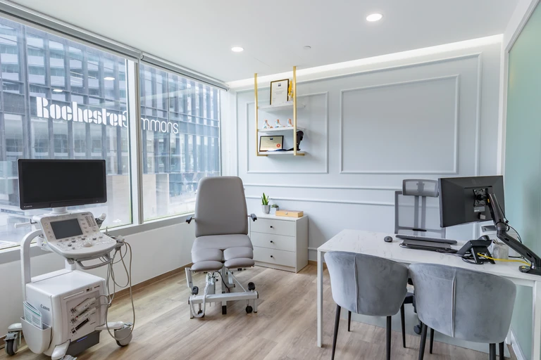 A consultation and assessment room at the Straits Podiatry Buona Vista clinic, with a treatment chair and clinician workstation.