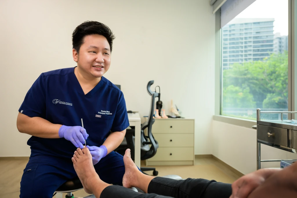 Podiatrist at Straits Podiatry assessing and treating Toe Pain in Singapore
