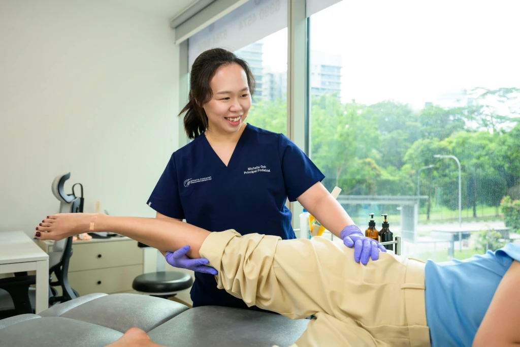 Podiatrist Michelle Goh performing a hip assessment for a lady with hip pain
