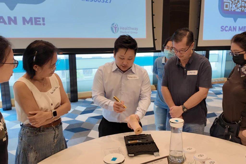 Mr Daniel Wong demonstrating wart cryotherapy to other doctors at a educational talk.