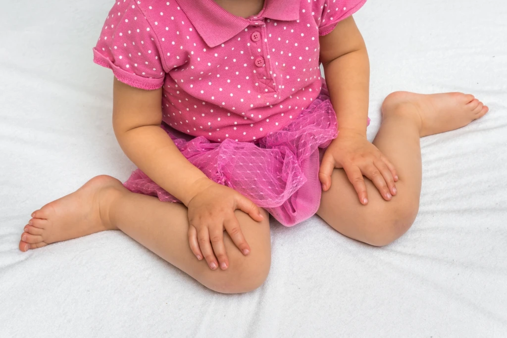 Girl in her toddler stage sitting in a W-sitting position, which is a known cause for in-toeing